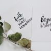 green rose leaves and two cards flat lay photography